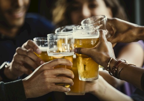 A group of people clinking glasses of beer in a toast, creating a celebratory and cheerful atmosphere.